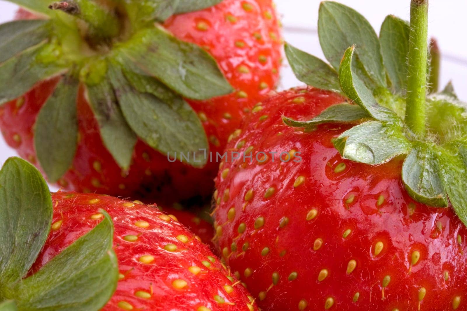 Close-up detail of strawberries on white background