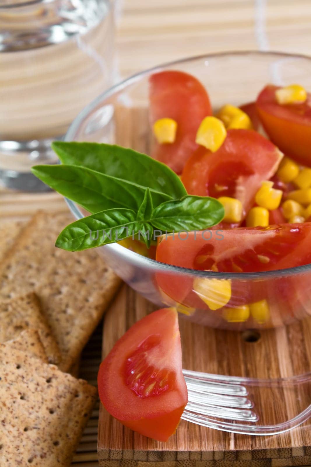 Tomato salad in a glass bowl on the table