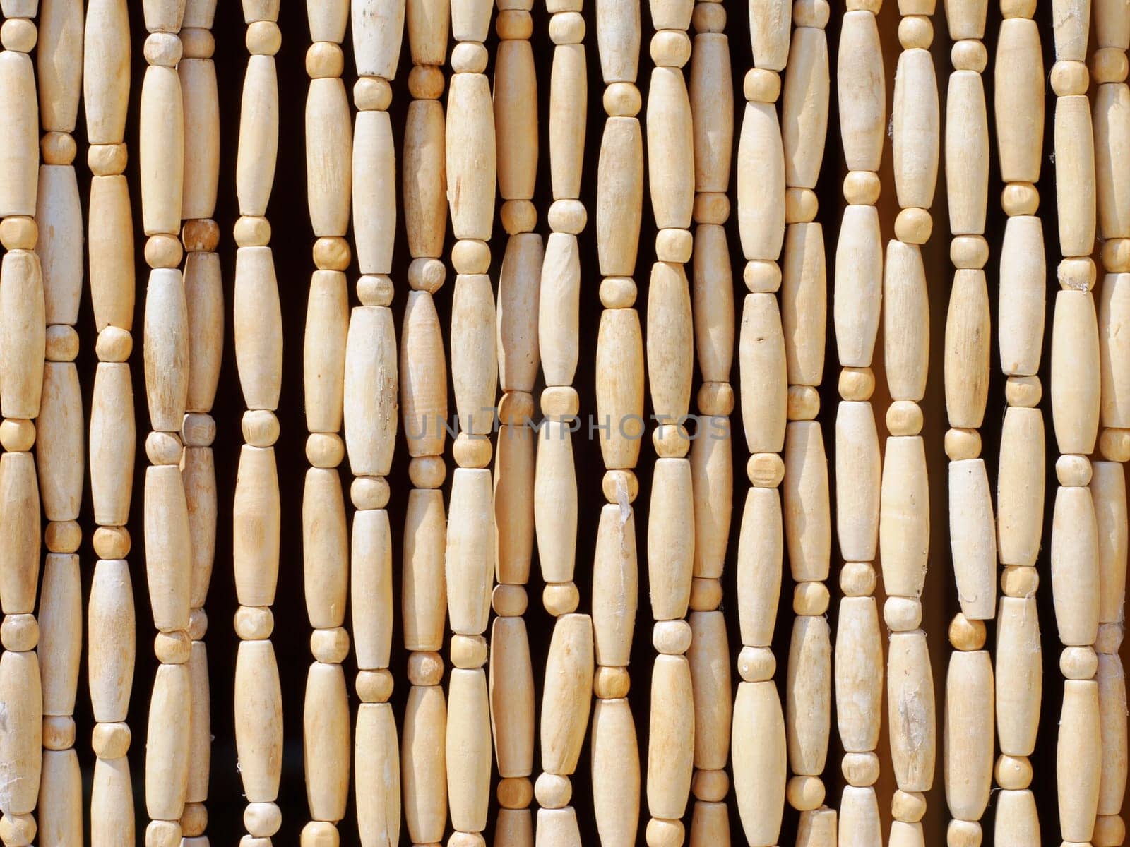 Natural patterns of wooden beeds hanging vertically
