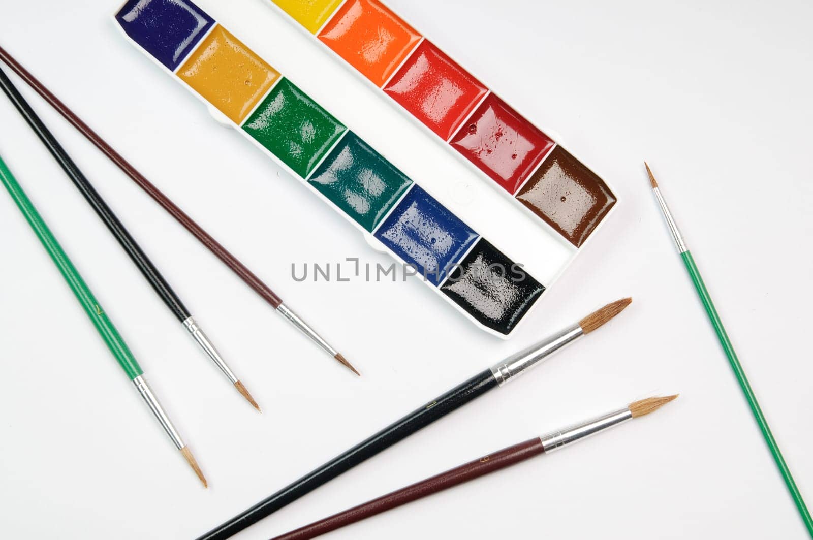 Paintbrushes, paint, and paper