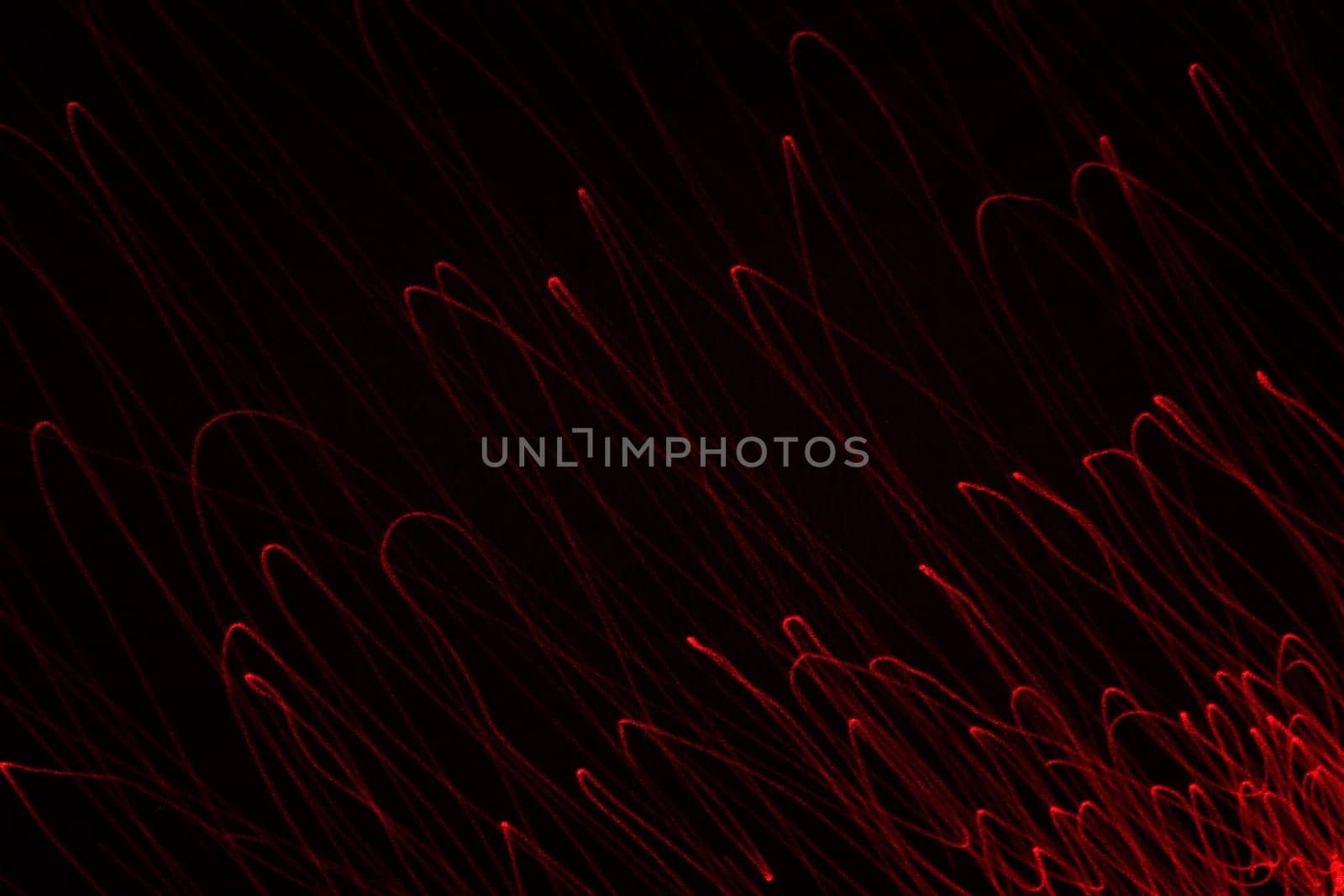 An abstract light background showing motion blurred light on a dark background.