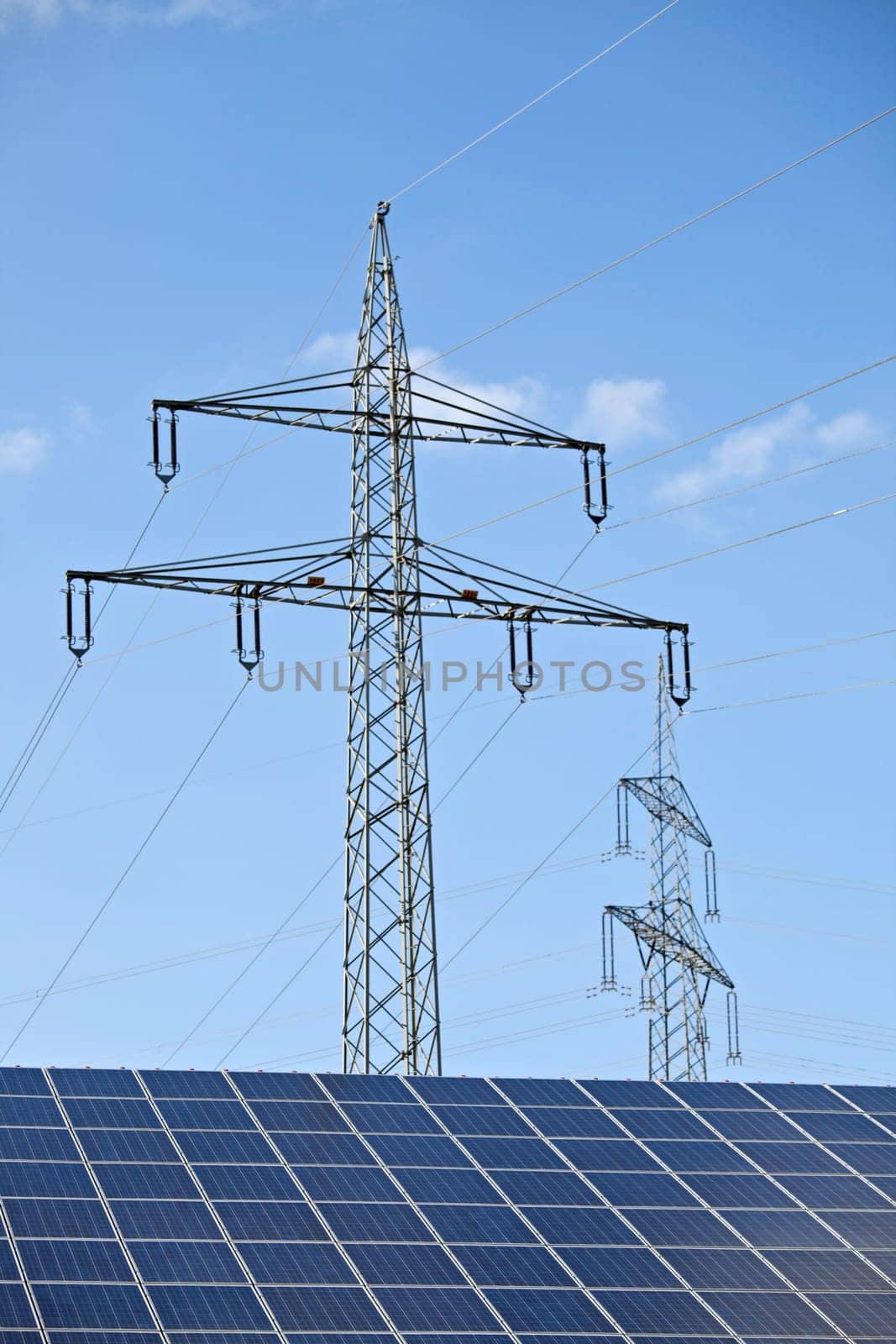 solar panels and a pylon on a sunny day