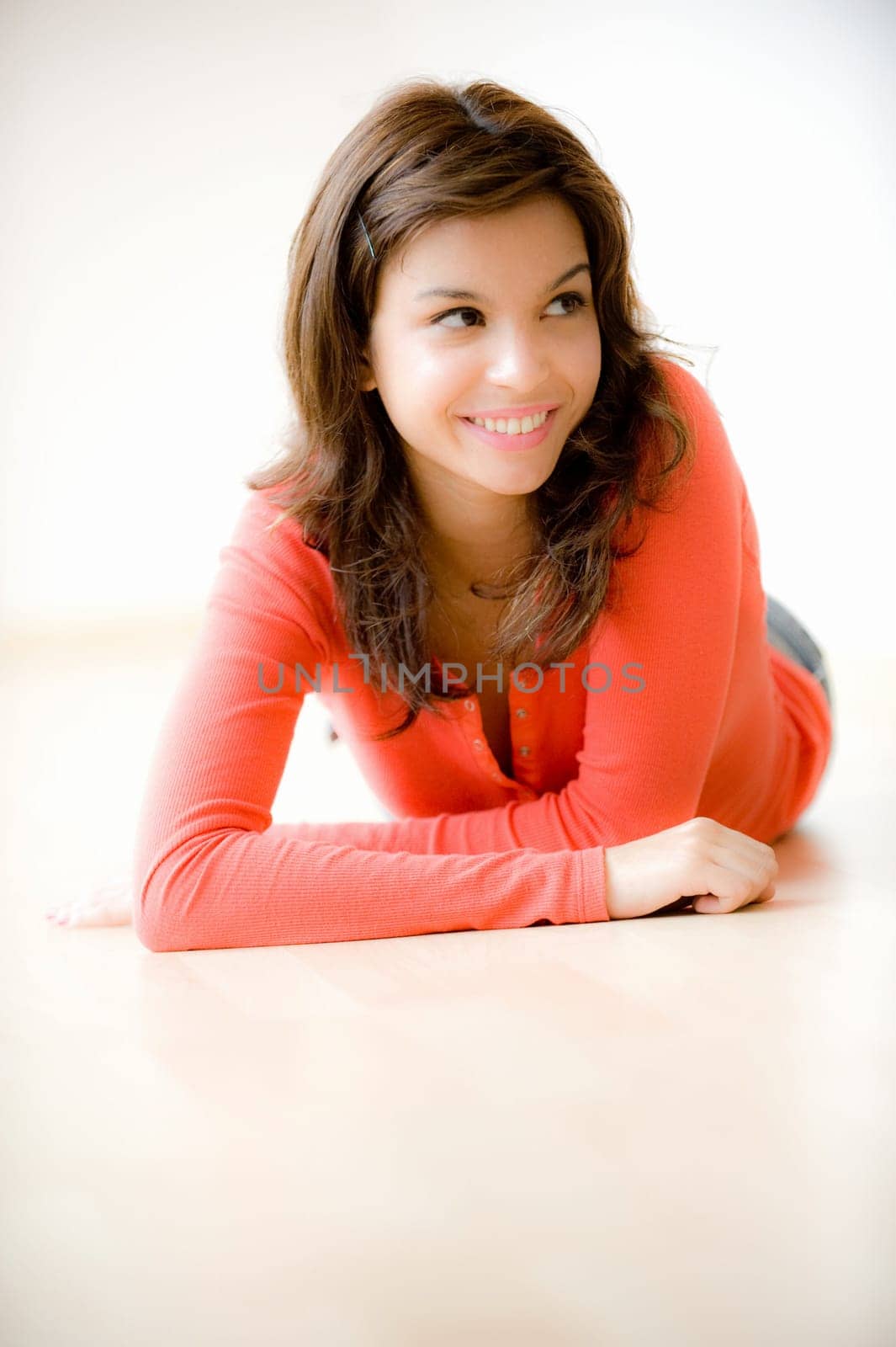 A young woman lying on the floor at home