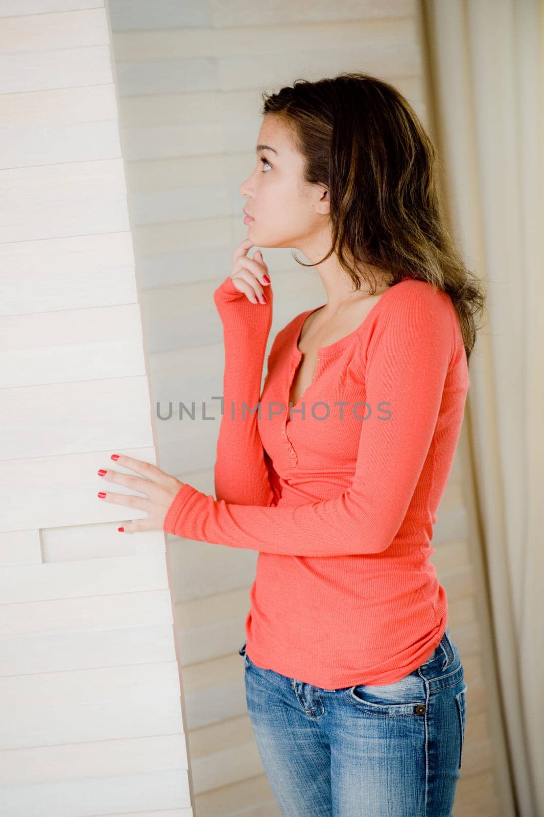 A young woman looking in her wardrobe trying to decide what to wear