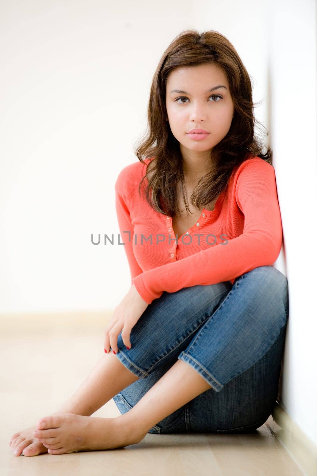 A young woman sitting on the floor at home