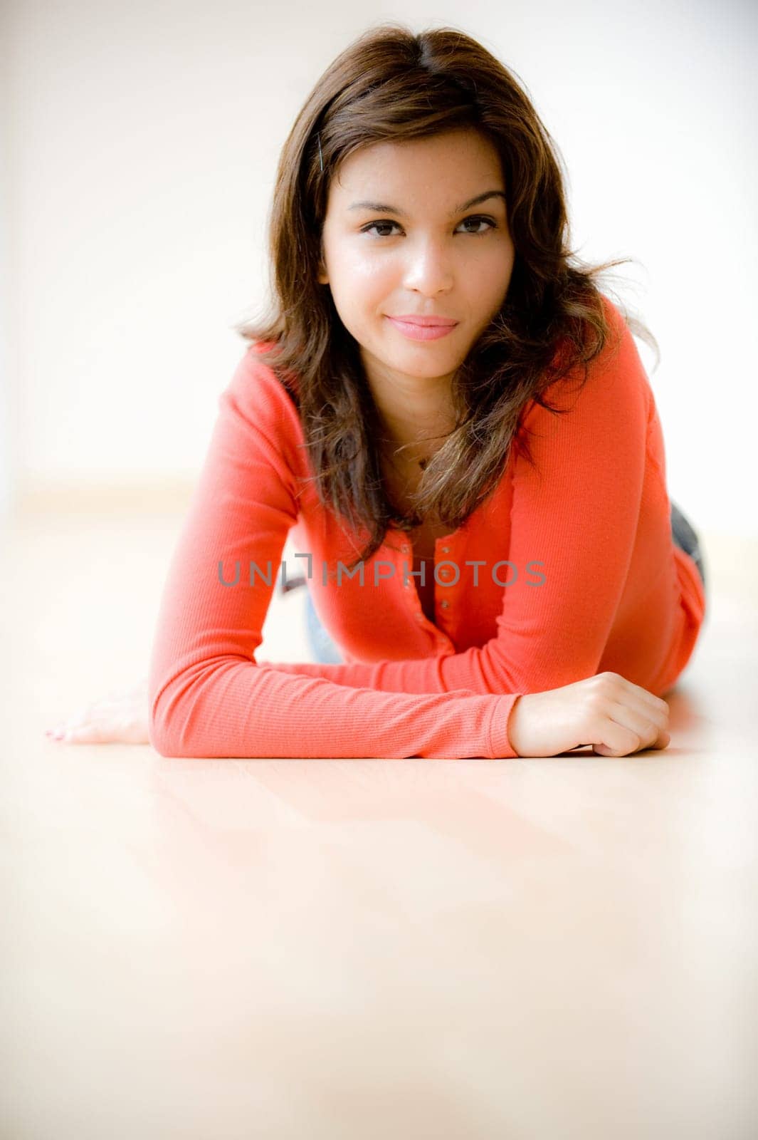 A young woman lying on the floor at home