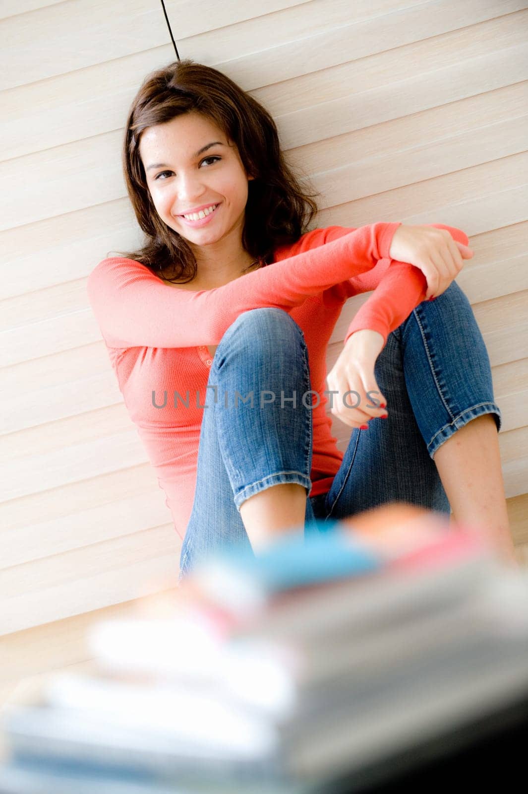A young woman sitting on the floor at home