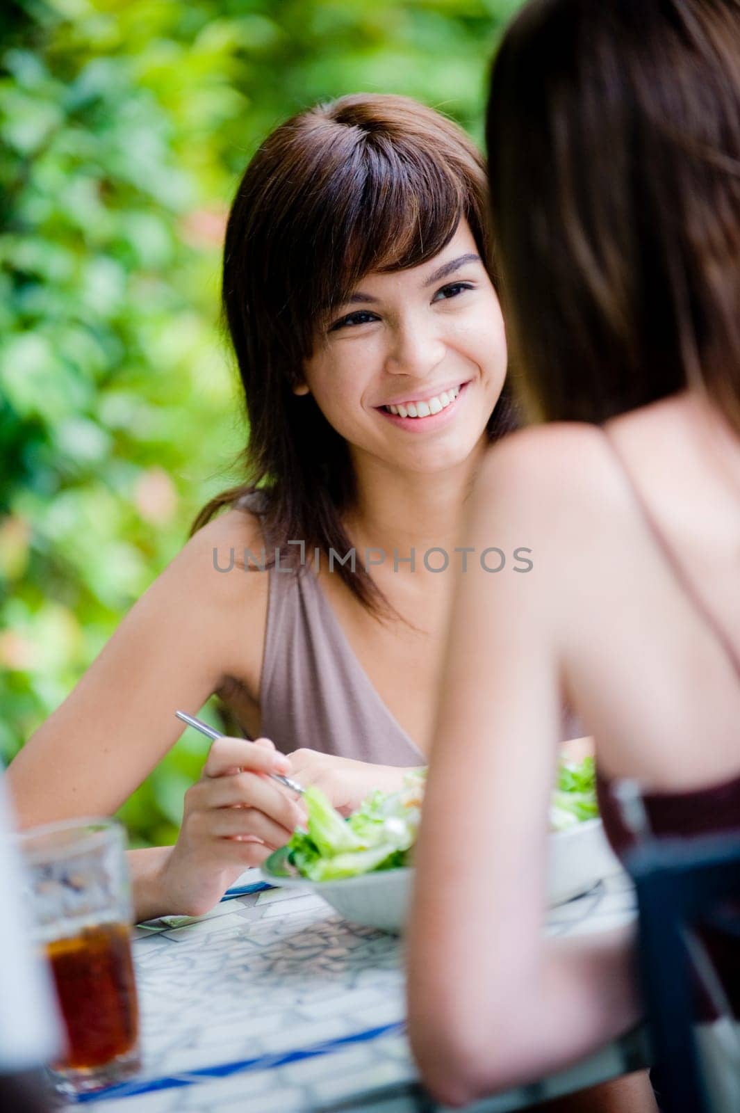 Two young attractive women having lunch together outside
