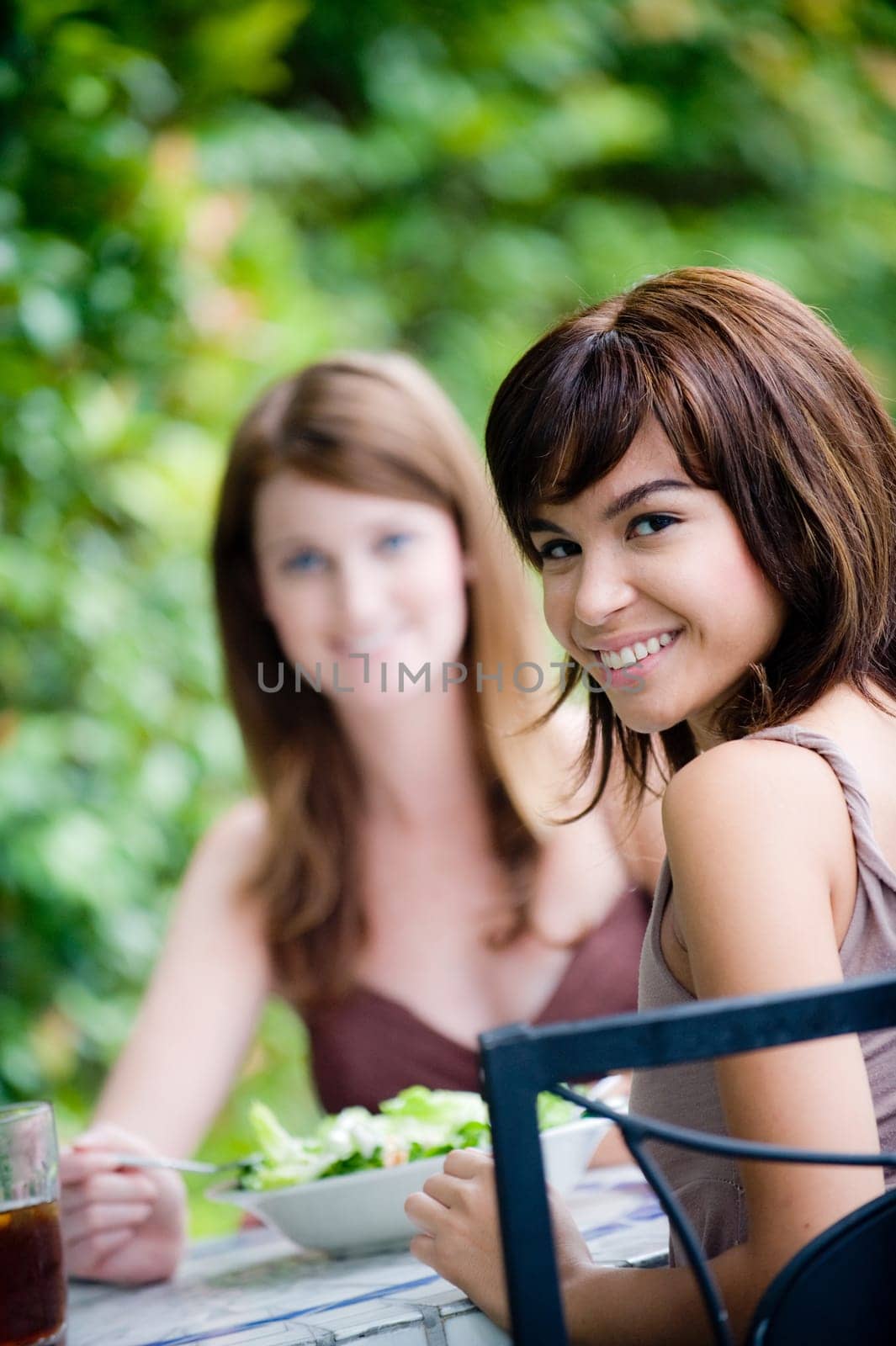 Two young attractive women having lunch together outside