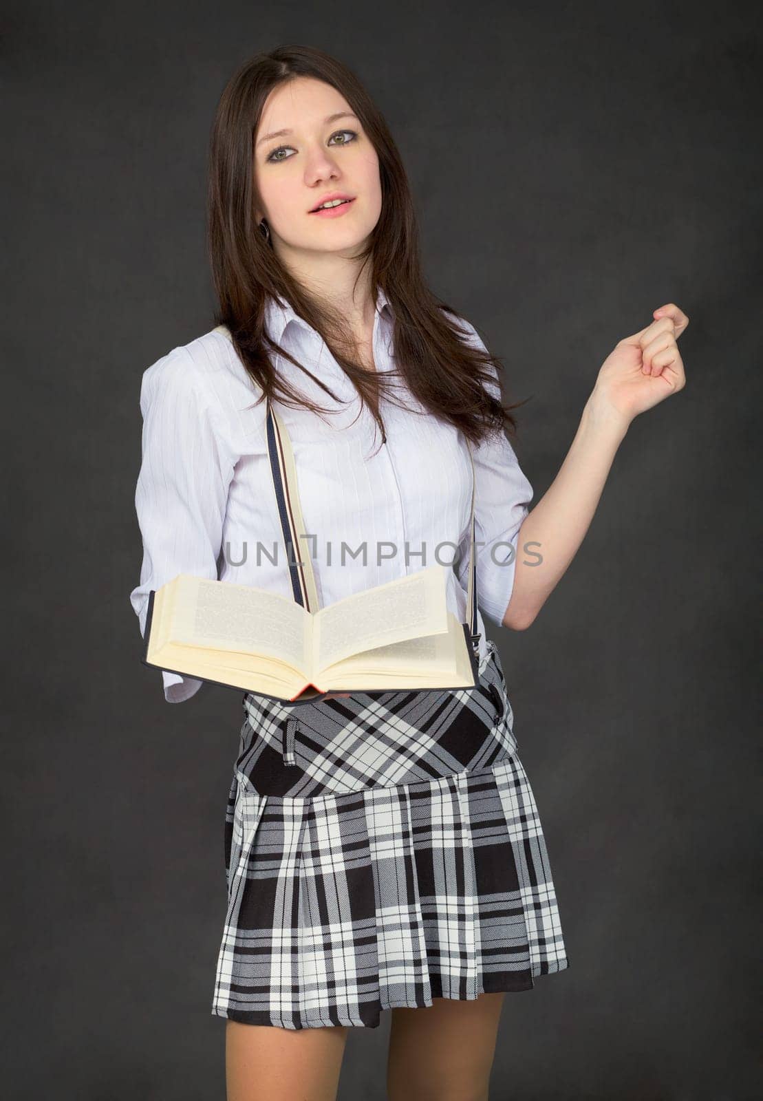 Girl with the book in hand on black background