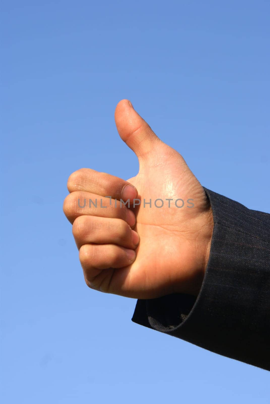 man's hand showing OK! isolated on blue