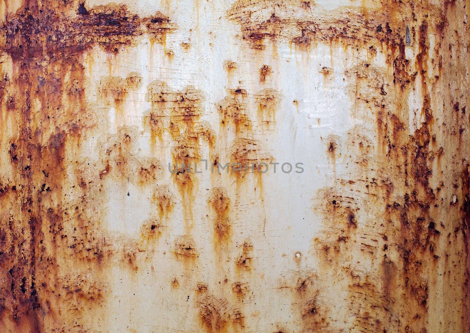 The rough red rusty old peeled metal wall surface
