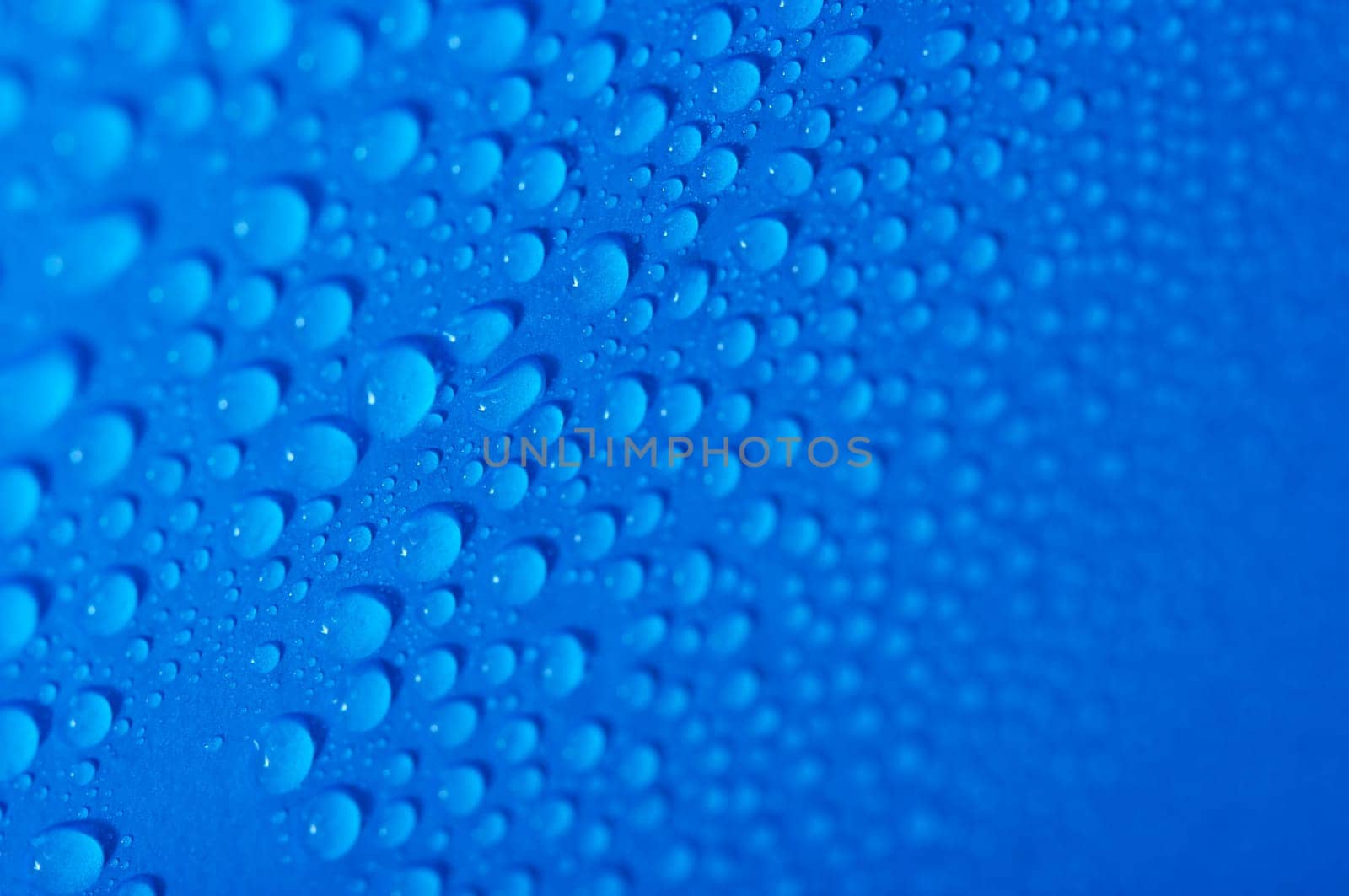 Water drops on a blue surface, shallow DoF