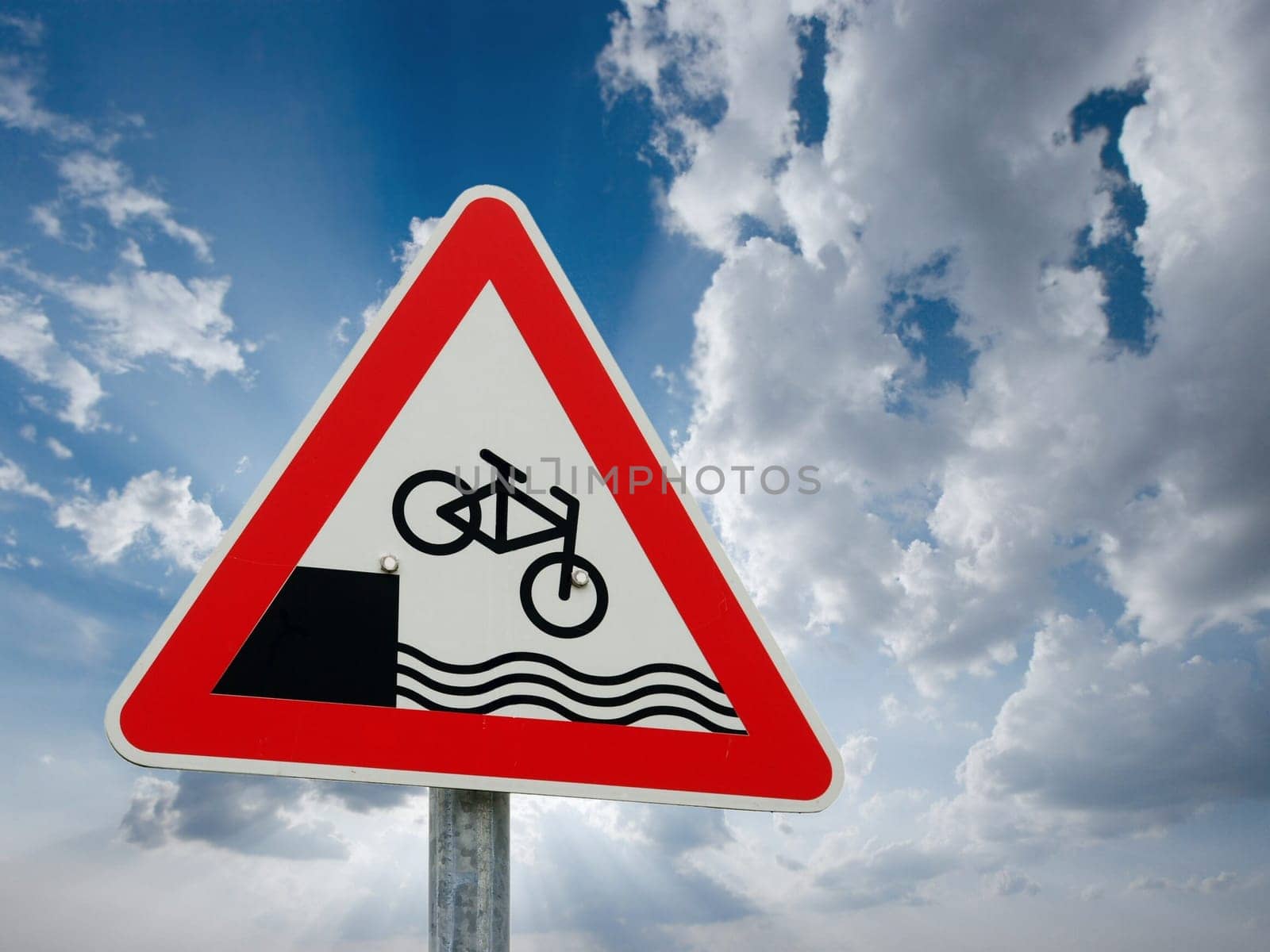 Traffic sign showing a bicycle falling down into the waves