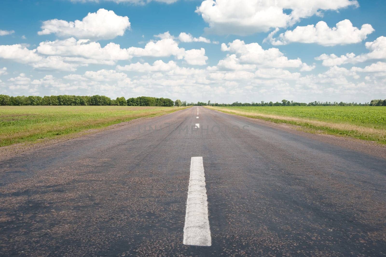 Road. An automobile line and the bright dark blue sky