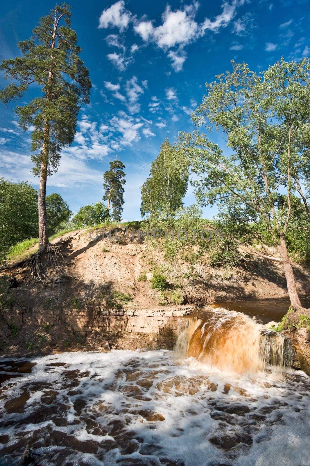 Small boisterous waterfall of a northern river