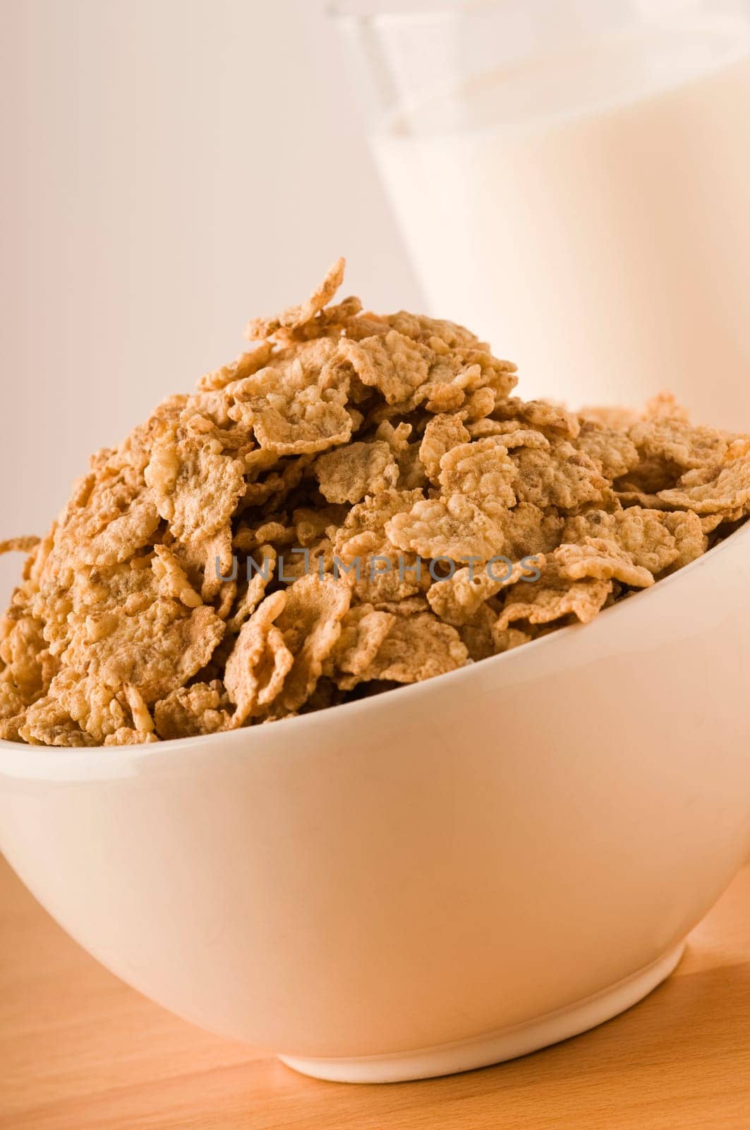 cereals in a bowl with milk glass to the bottom