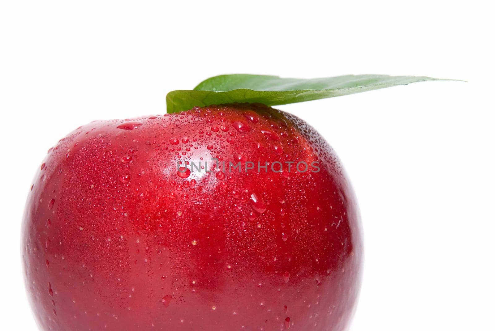 Close-up of ripe fresh red apple with leaf isolated on white