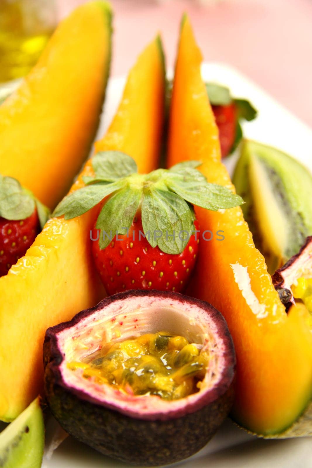 Strawberries and passionfruit with wedges of cantaloupe.