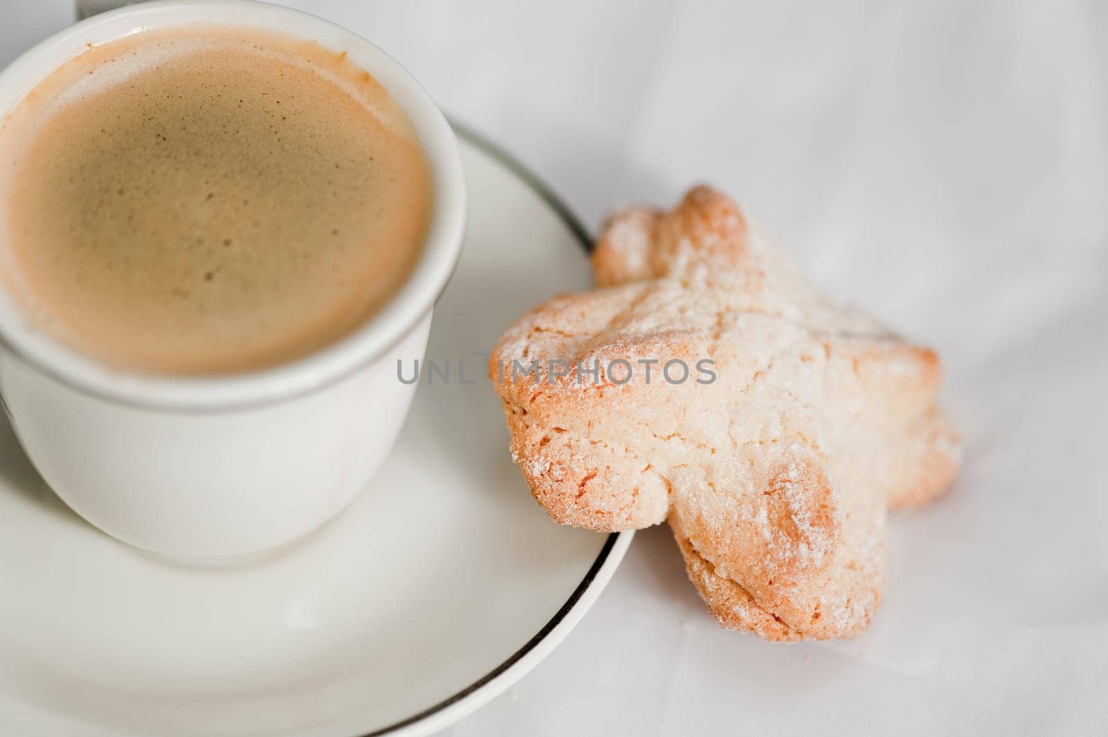 A cup of espresso with a cookie