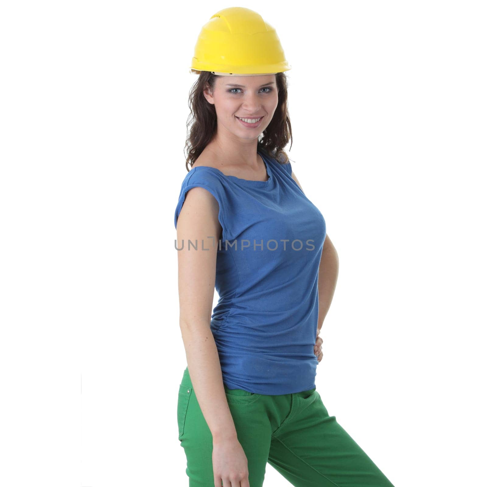 Young female architect or builder wearing a yellow hart hat on a construction site