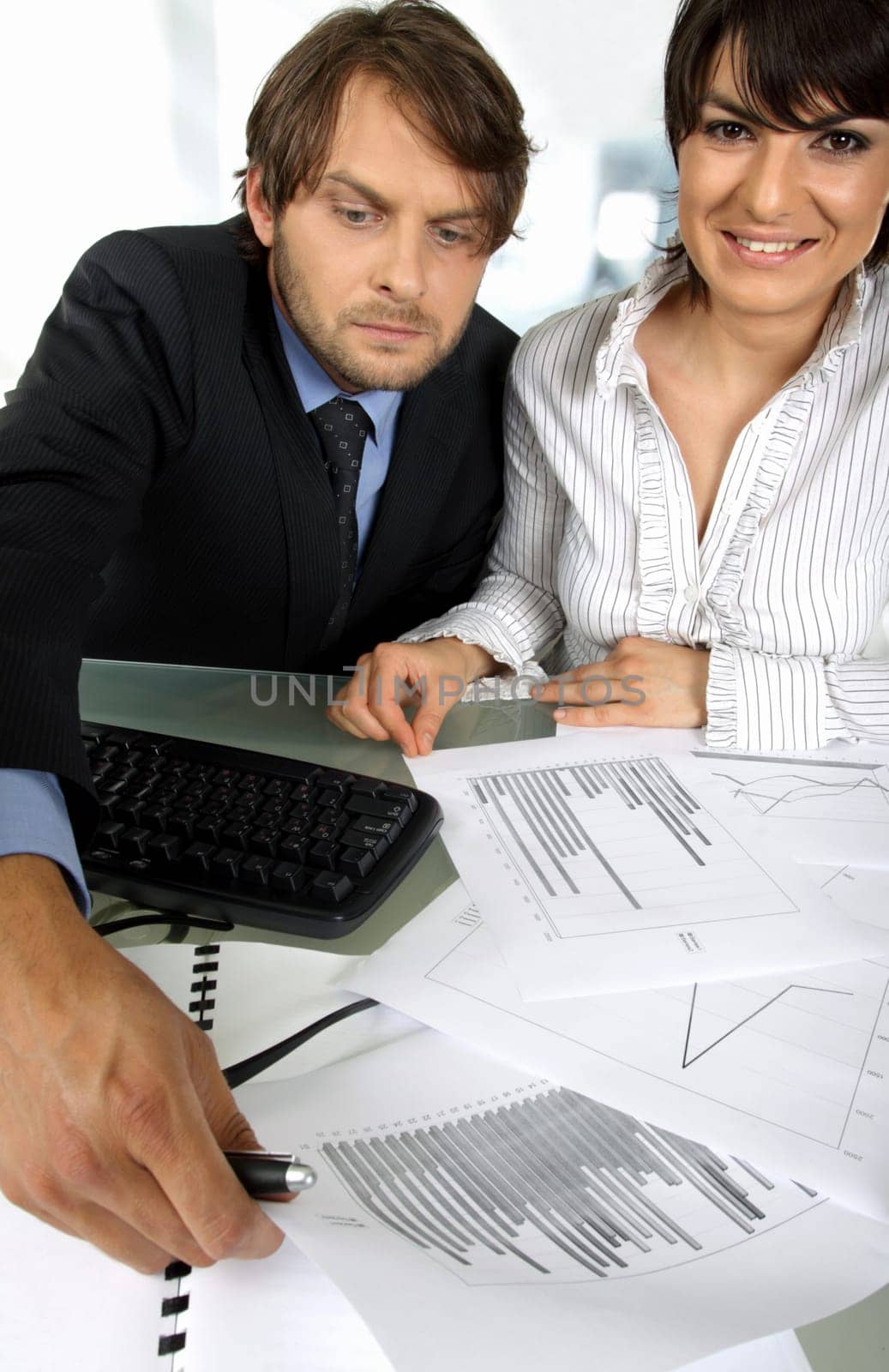 business couple is making an analyses looking at graphics