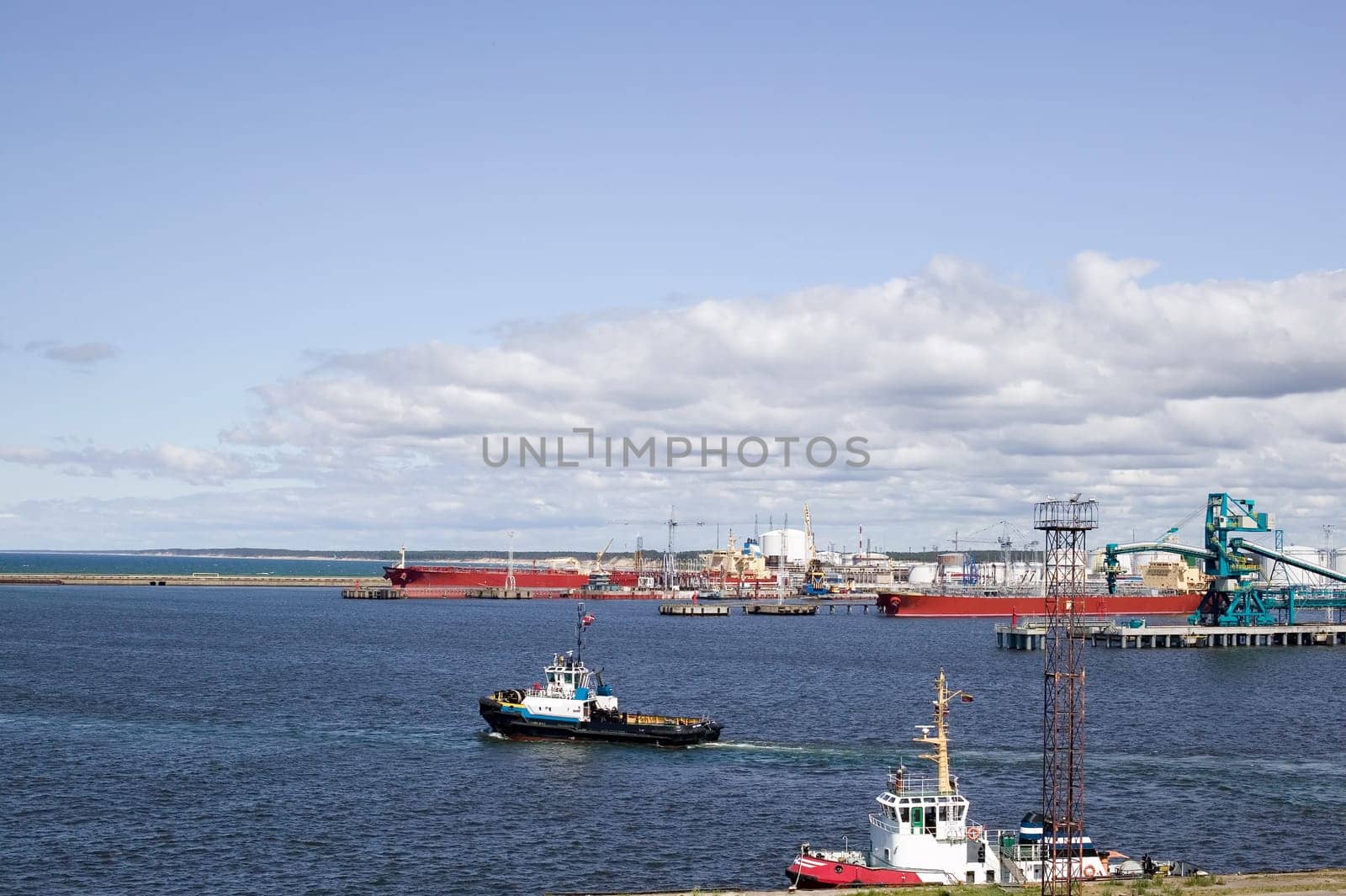 Harbour with many ships, sky with clouds, photo taken during trip near Baltic sea