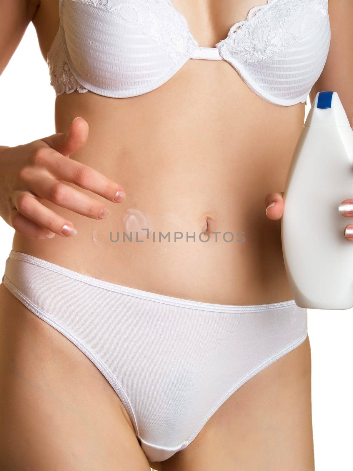 Woman applying creme to her stomach