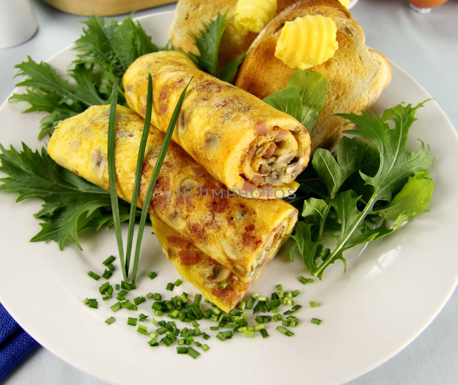 Delicious rolled mushroom and bacon omelette freshly prepared and ready to serve.