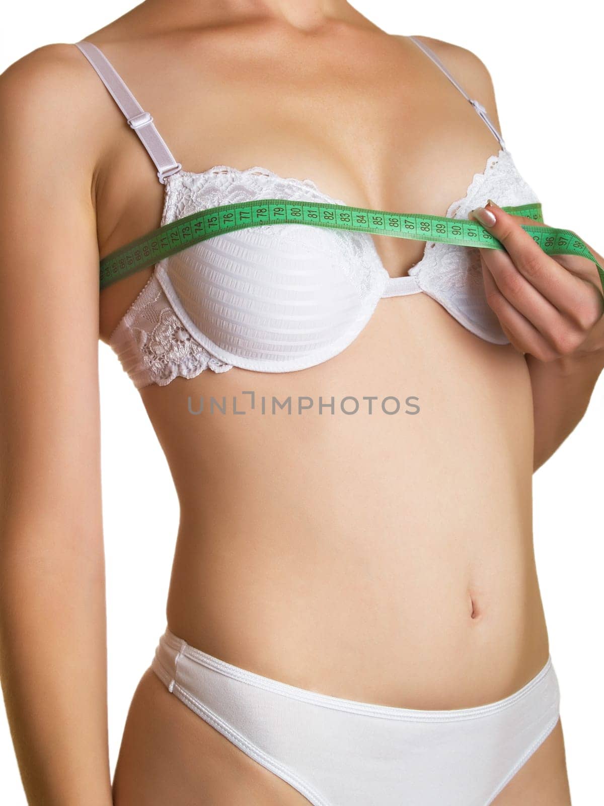 The young woman measures to itself a bust on a white background