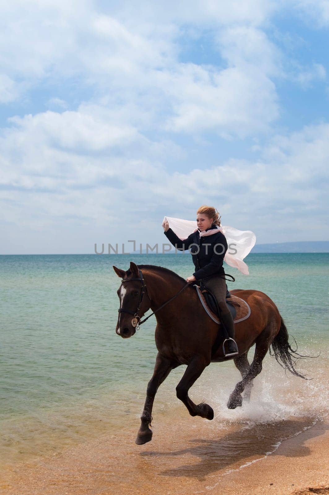 Girl on a horse galloping along the beach