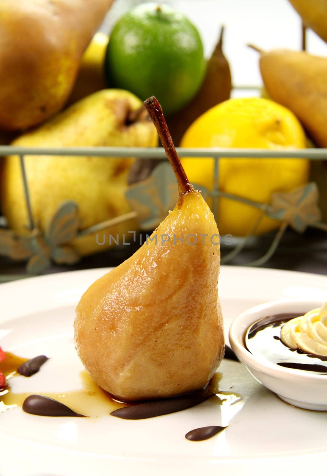 Delicious poached pear with chocolate syrup and cream.