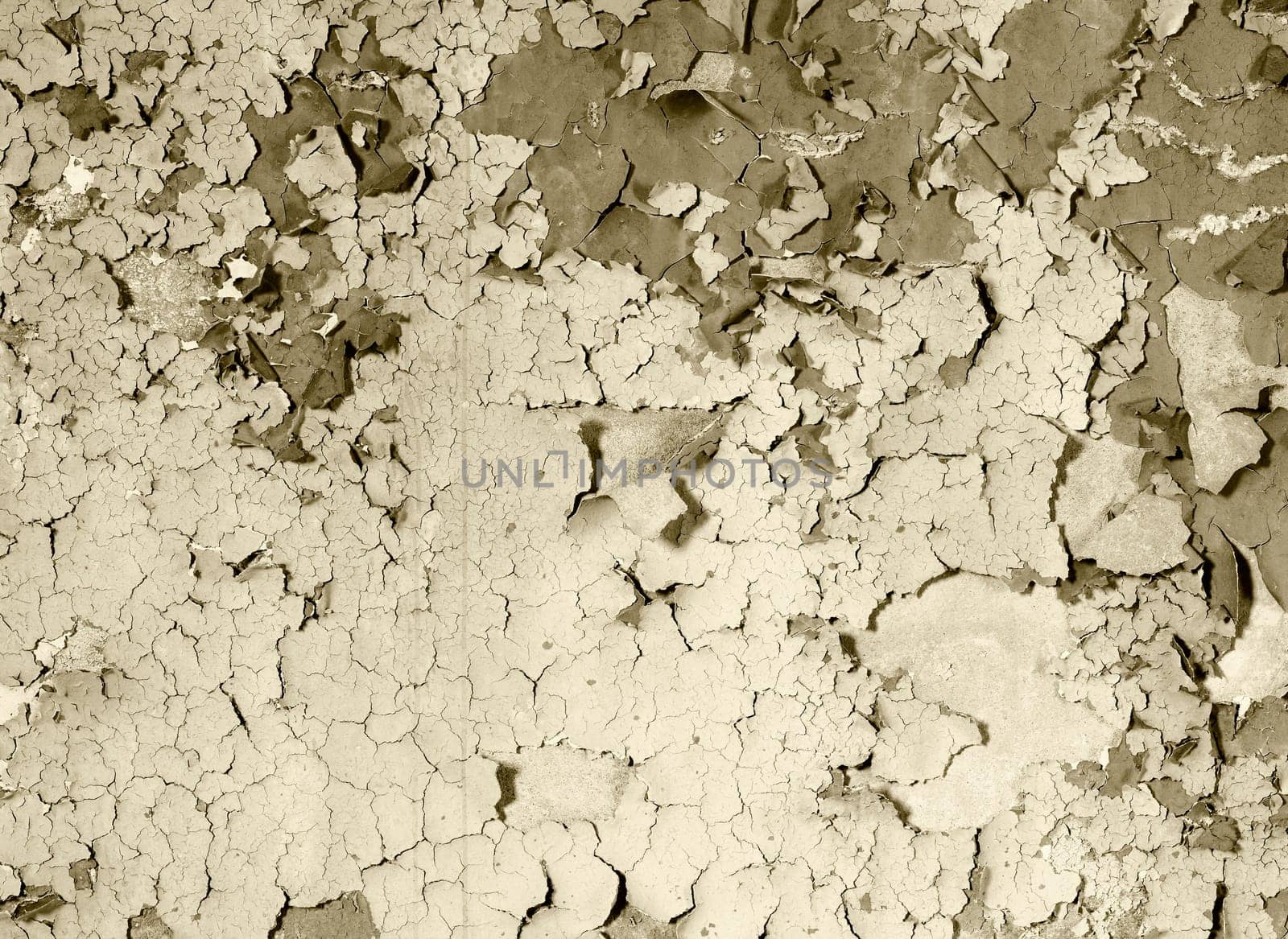 Old damaged paint on a concrete wall - sepia background