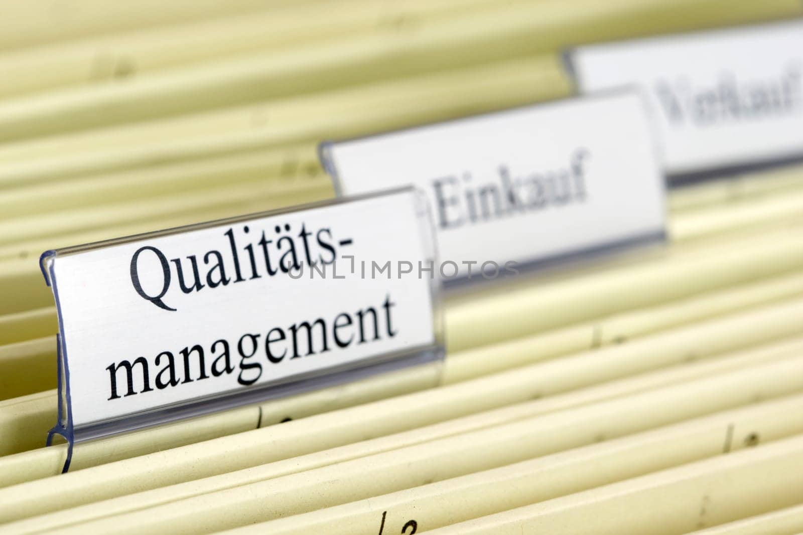 Close-up hanging files with tab "Qualitatsmanagement"" what means ""Quality Management"" in German"