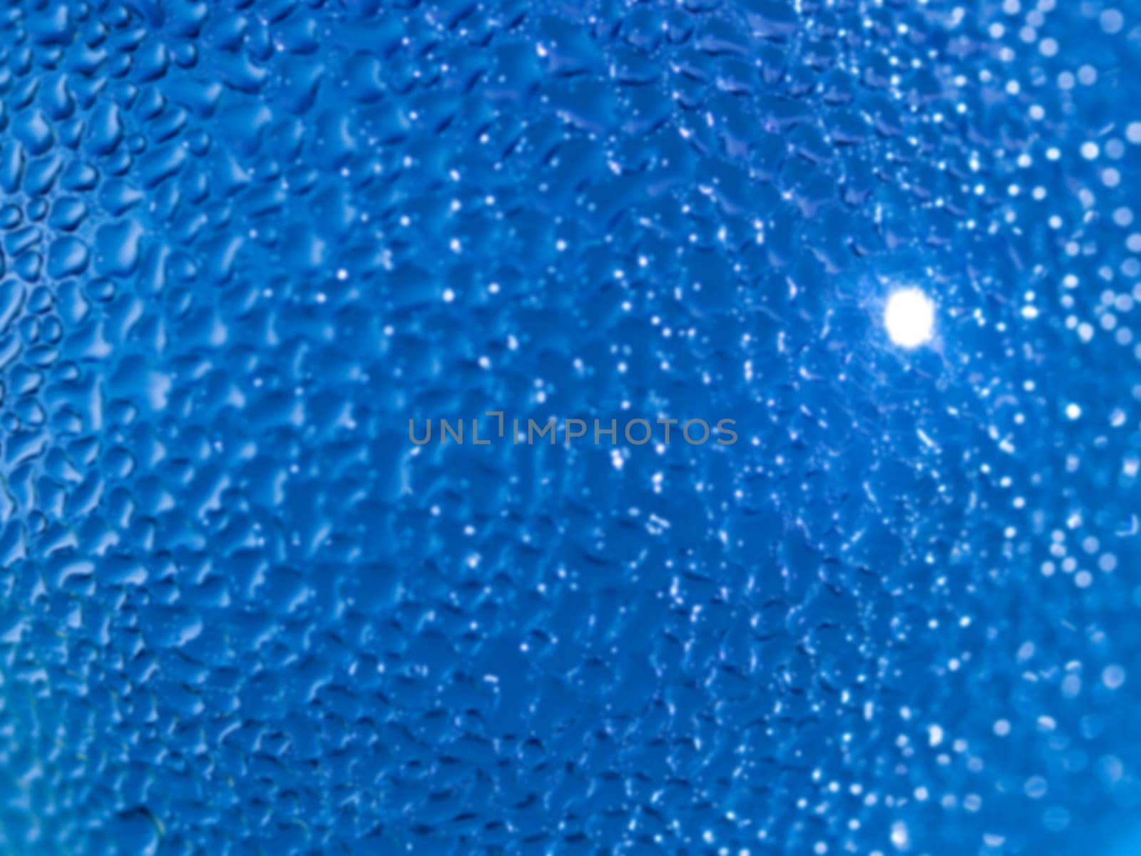 Water droplets formed from condensation inside a blue bottle
