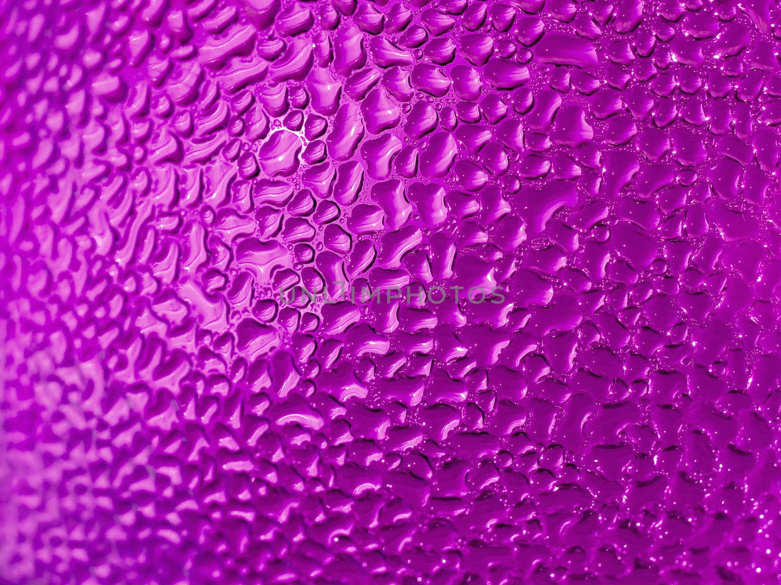 Water droplets formed from condensation inside a pink bottle