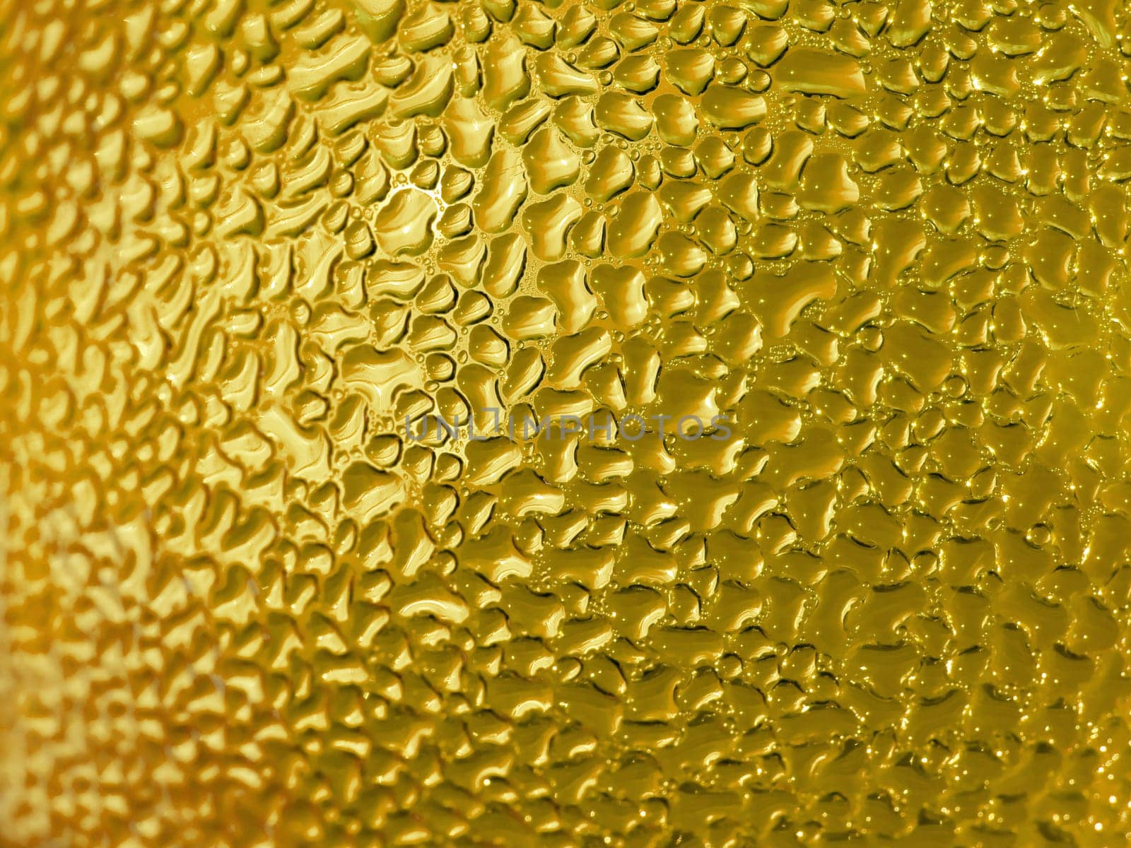 Water droplets formed from condensation inside a bottle gold tone