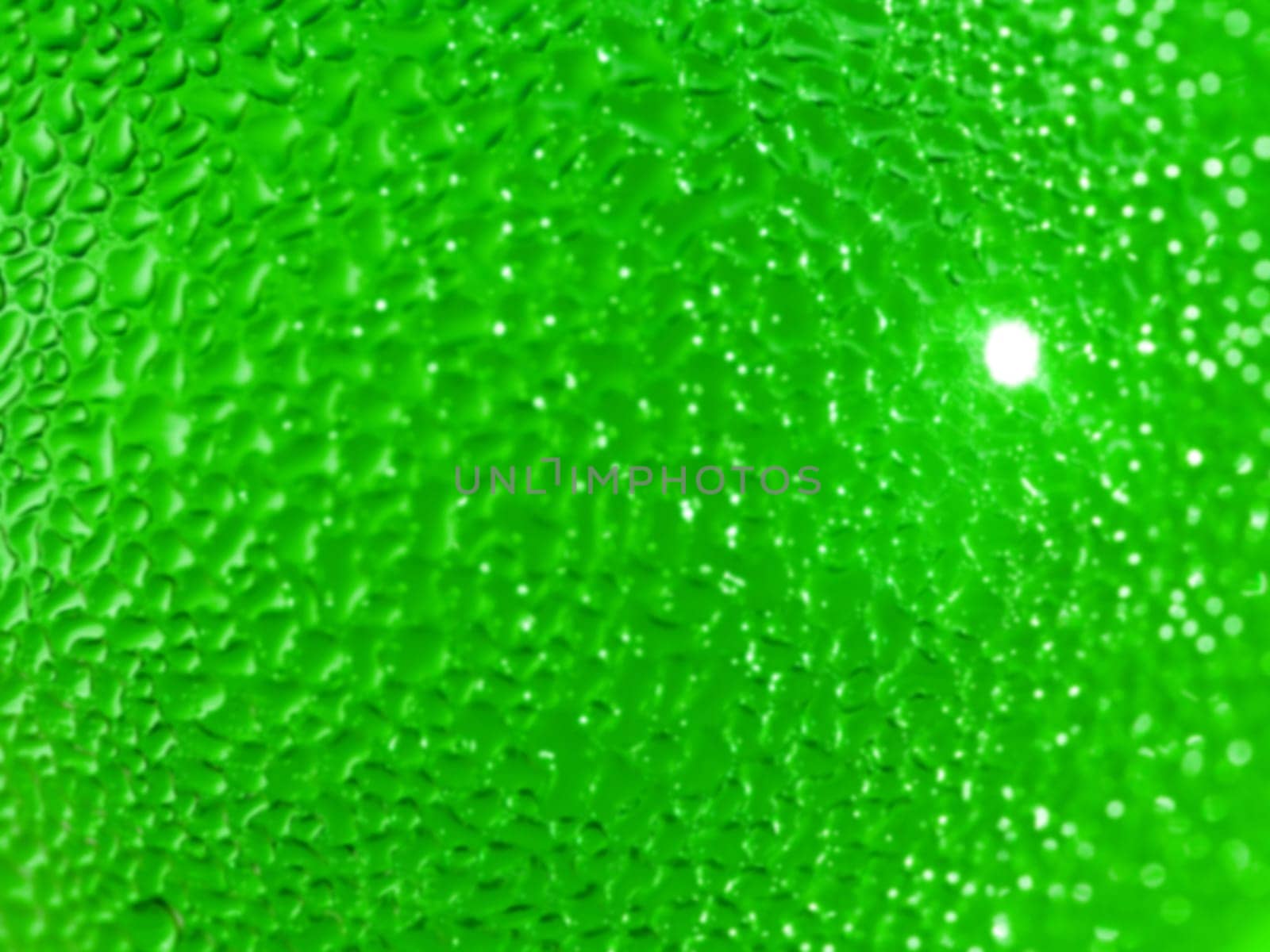 Water droplets formed from condensation inside a green bottle