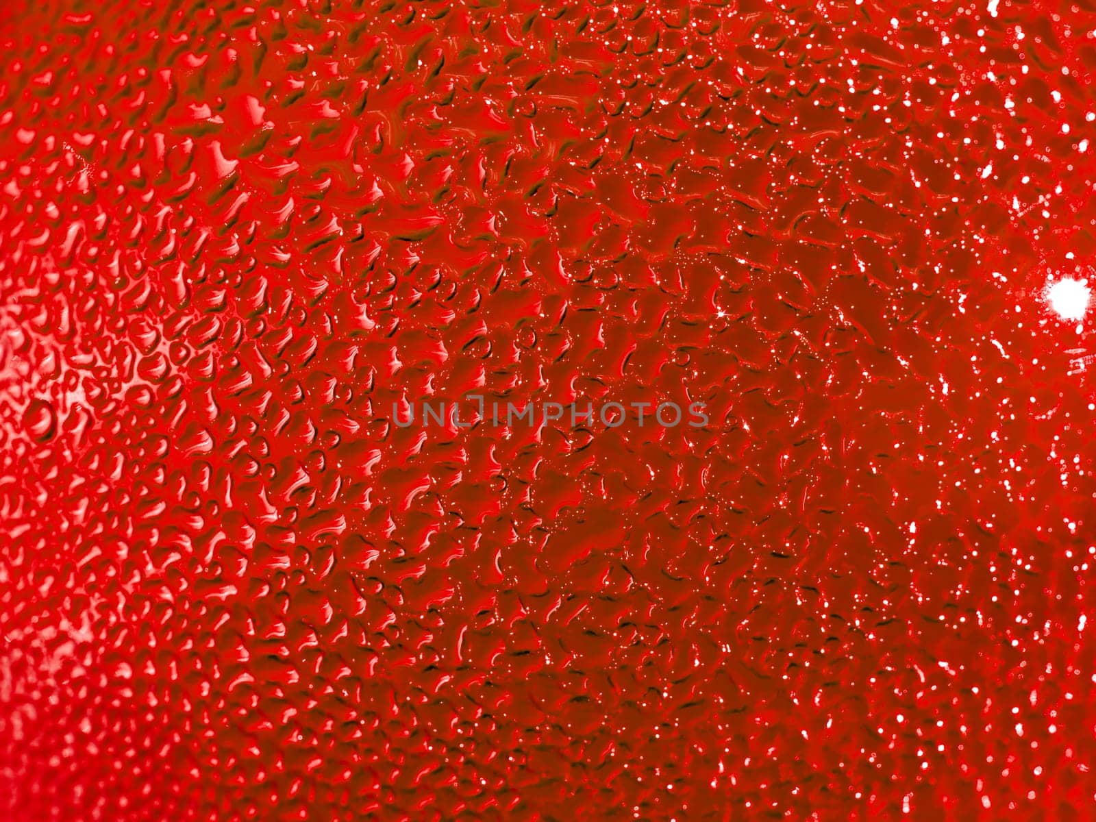 Water droplets formed from condensation inside a red bottle