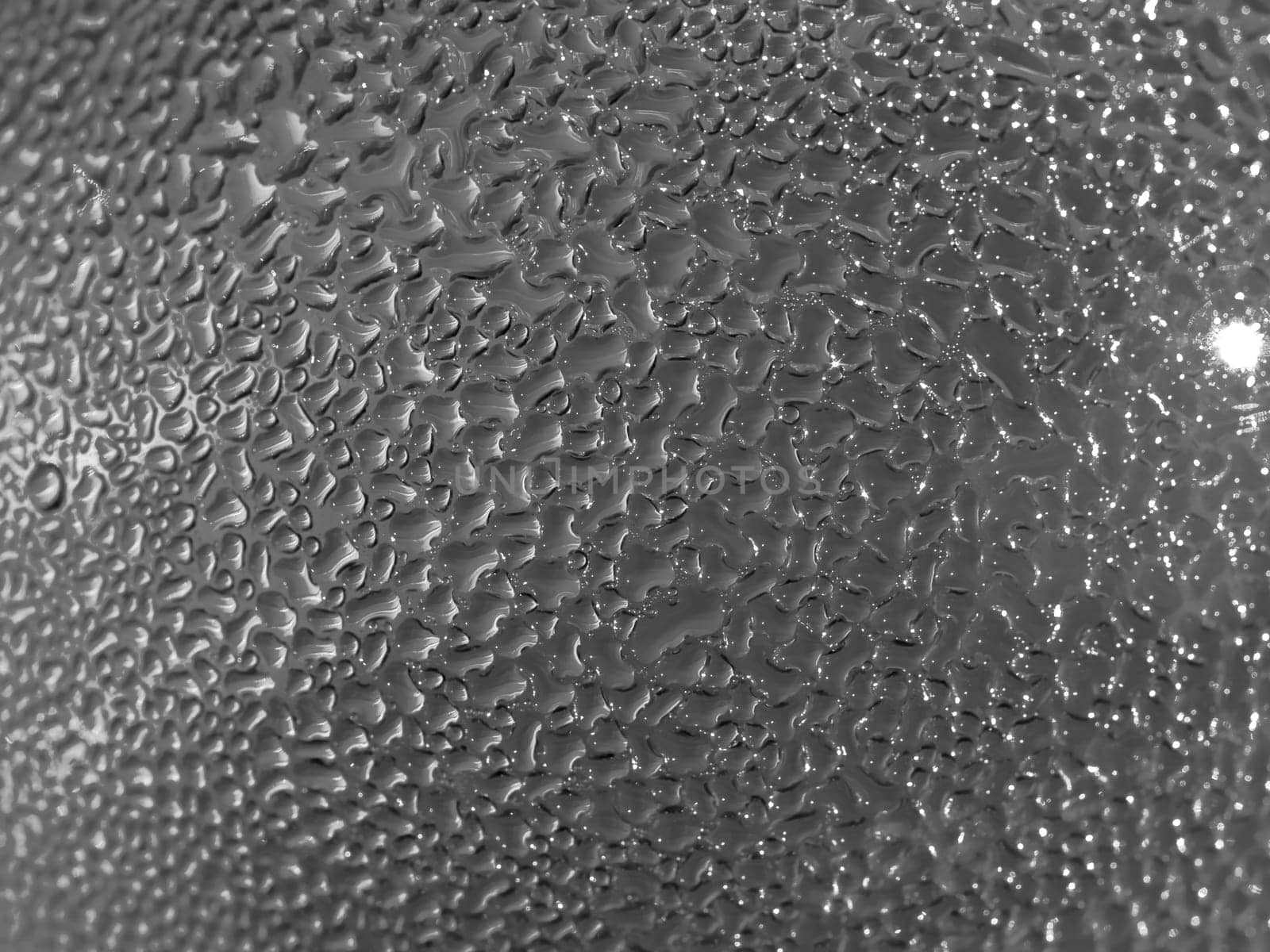 Water droplets formed from condensation inside a bottle silver tone