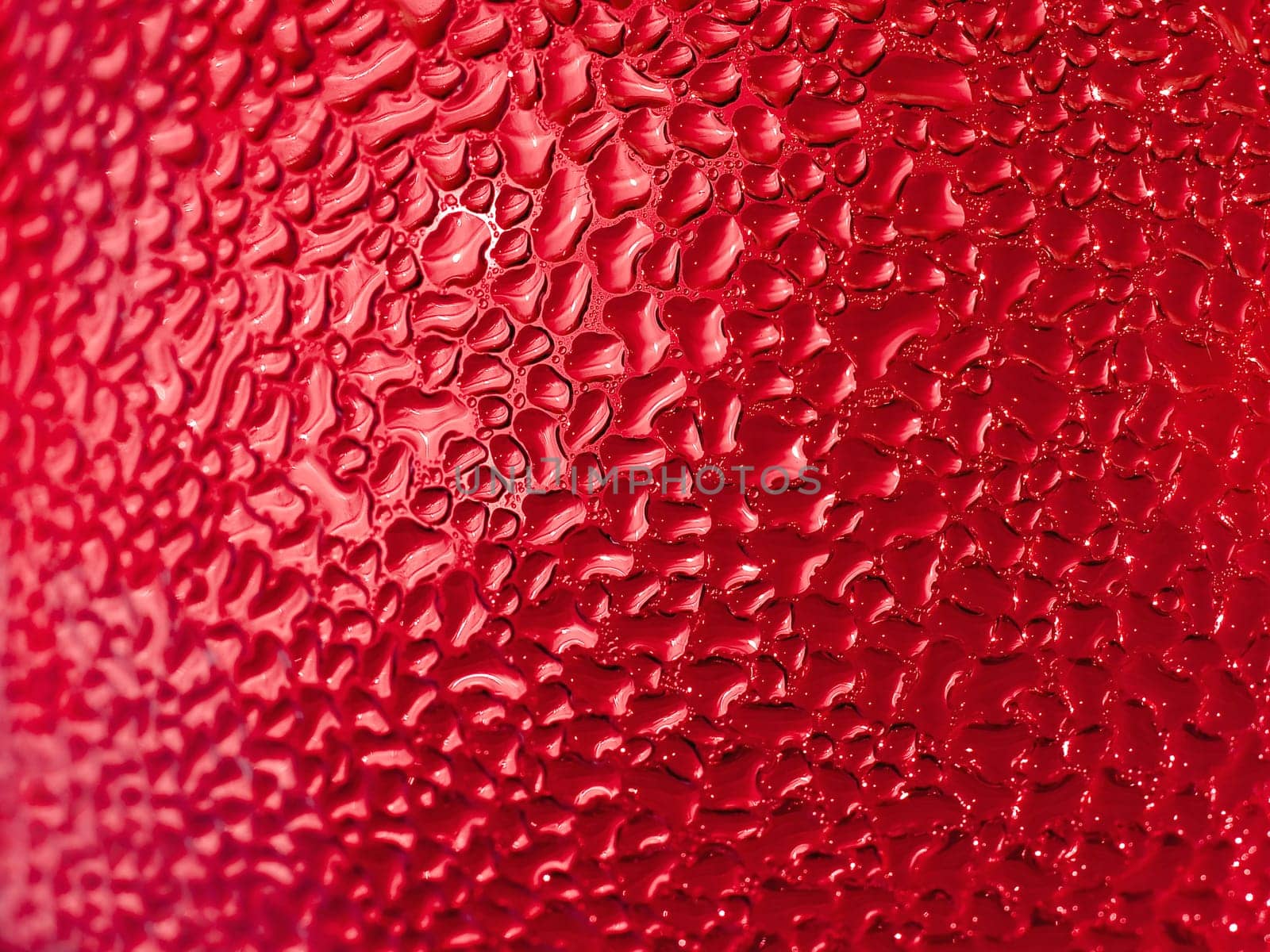 Water droplets formed from condensation inside a red bottle