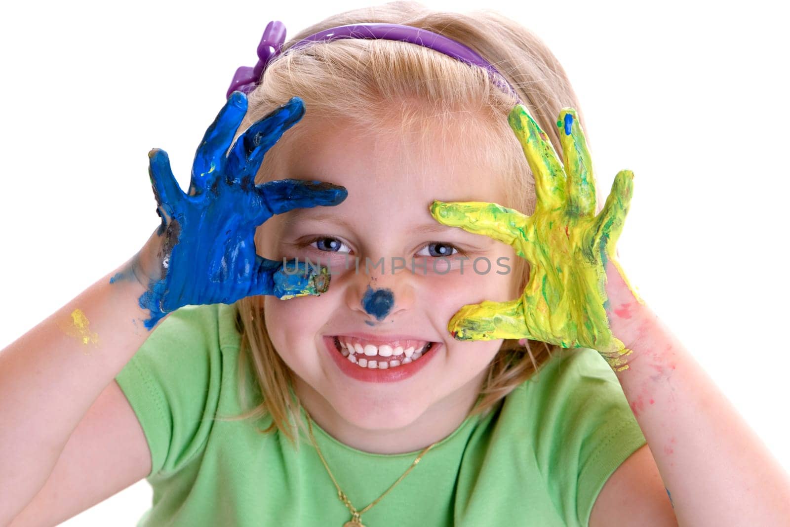 Young Child (Girl) smiles after painting session with colorful hands
