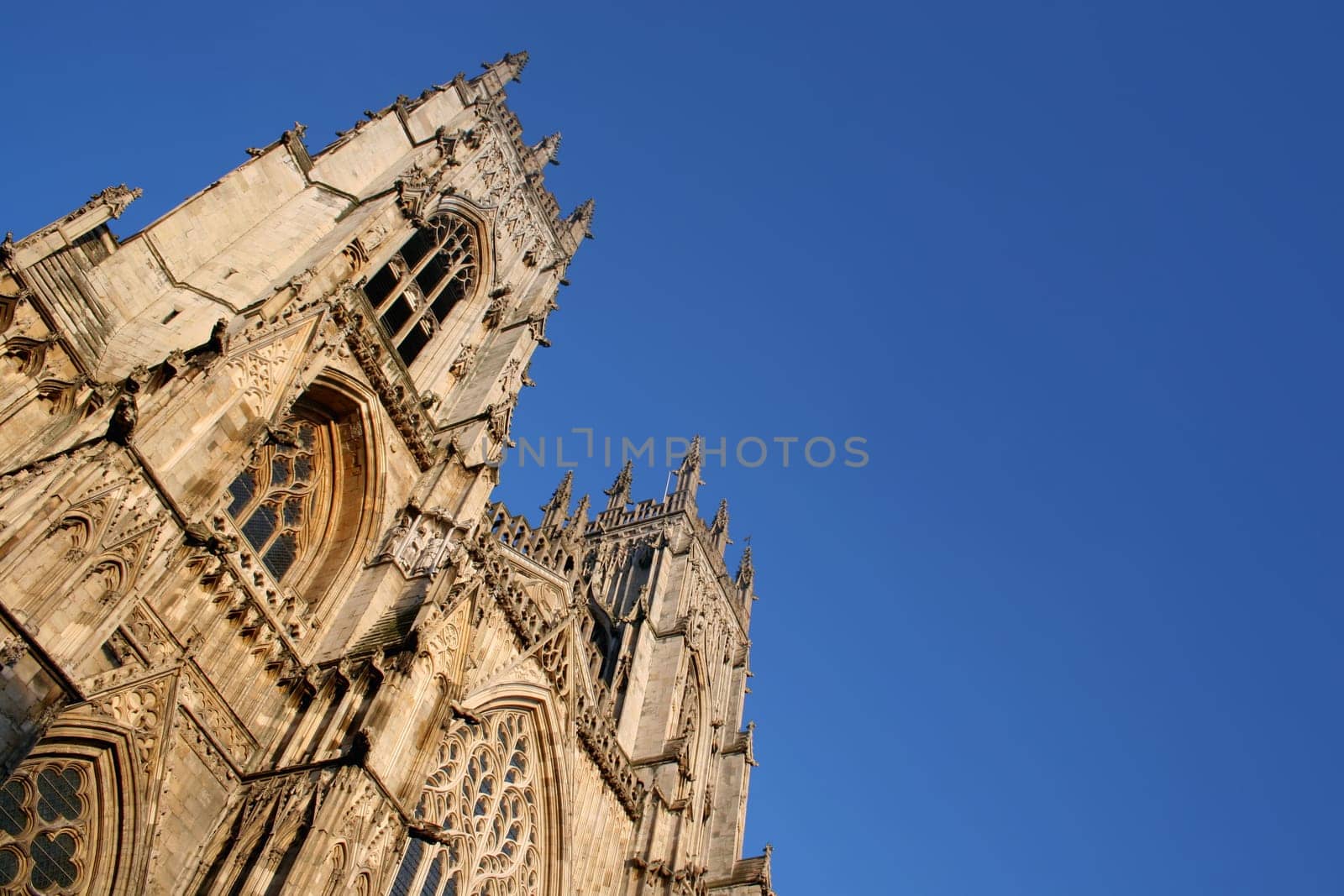 One of the oldest gothic cathedrals in Europe, York Minster Cathedral stands proud against a bright blue summer sky.