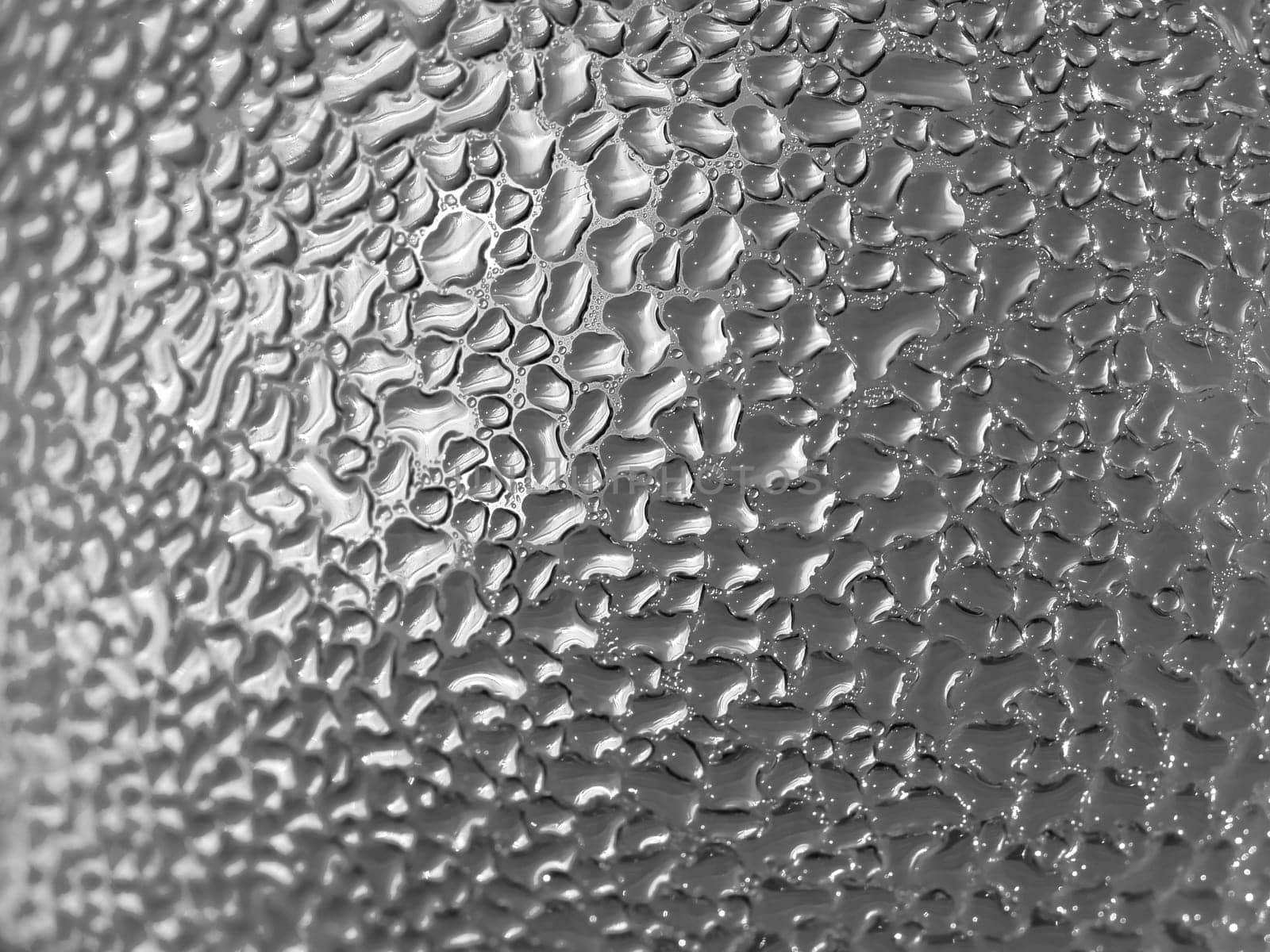 Water droplets formed from condensation inside a bottle silver tone