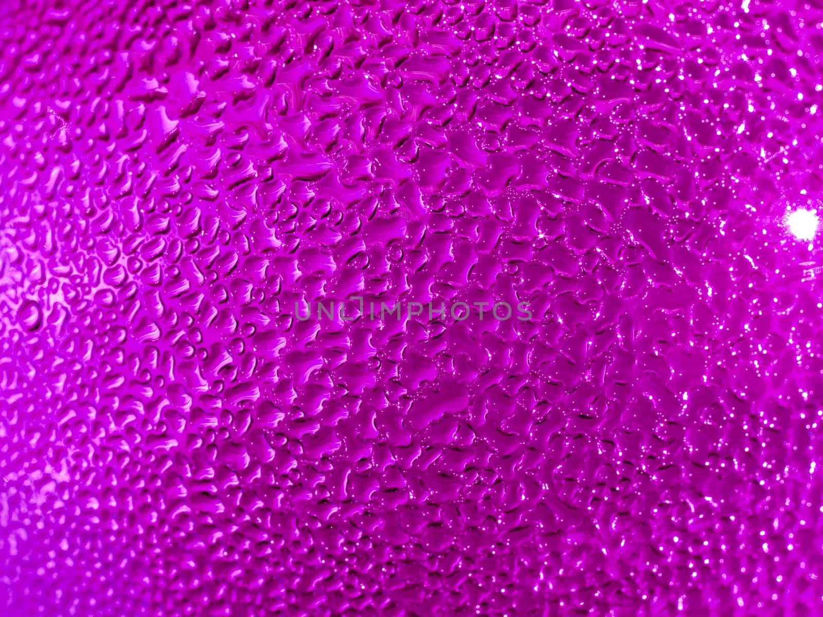 Water droplets formed from condensation inside a pink bottle