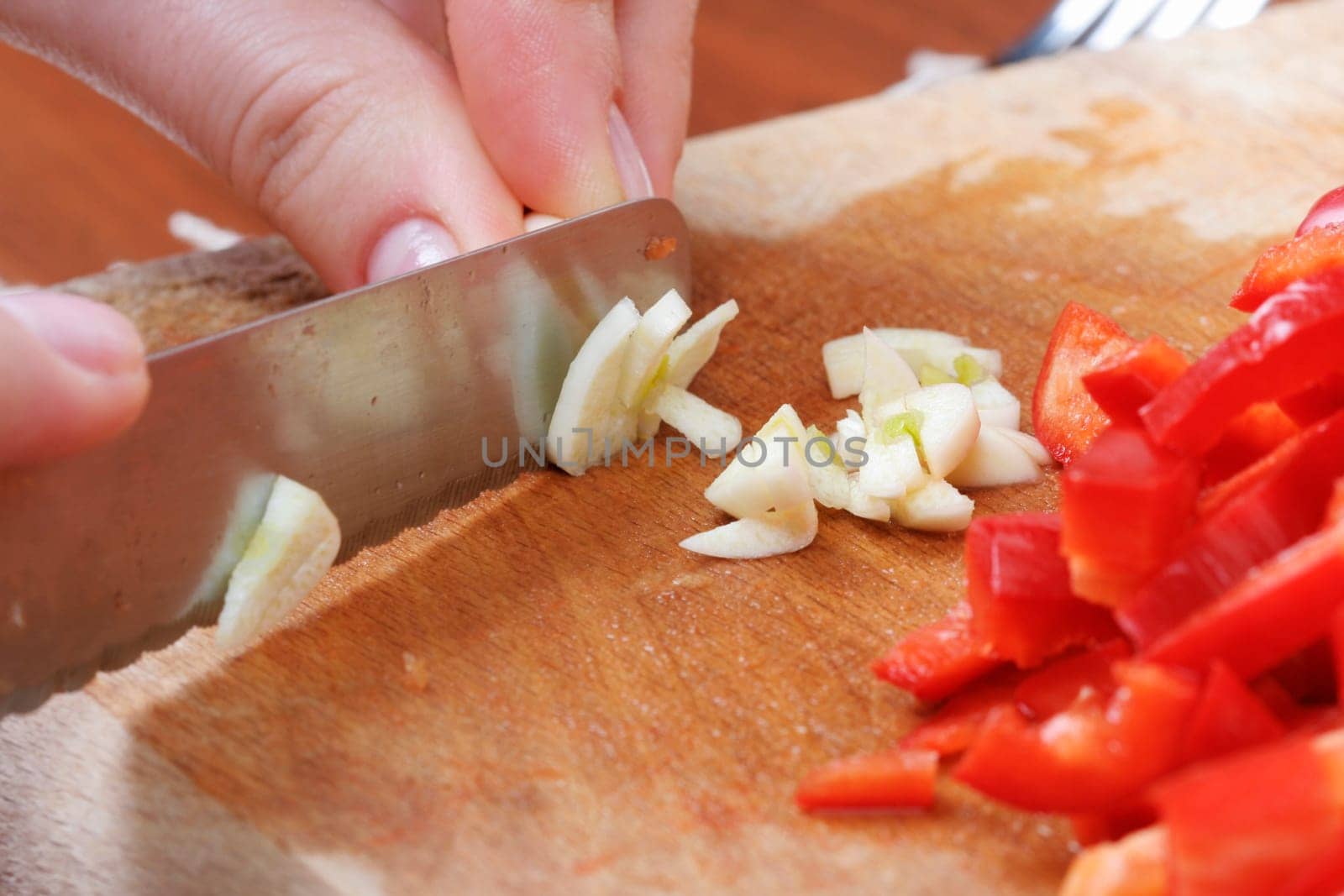 Chopping the garlic with knife.