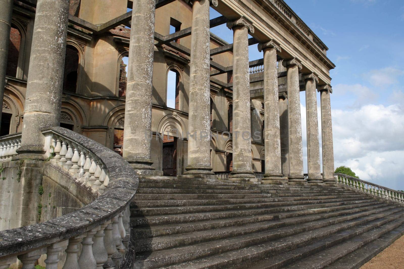 The steps and pillars of an entrance to Witley Court, a once-magnificent country house in Worcestershire, England, which was ravaged by fire in 1937 and now stands as an empty shell.