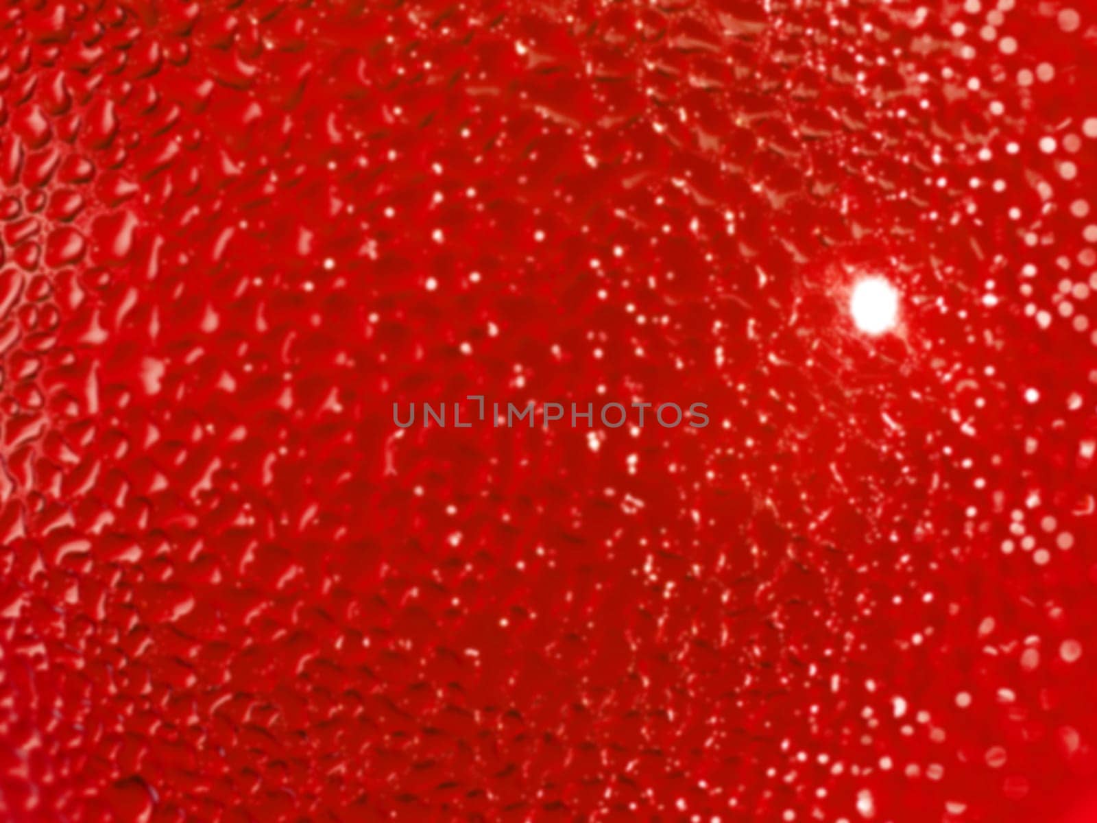 Water droplets formed from condensation inside a red bottle