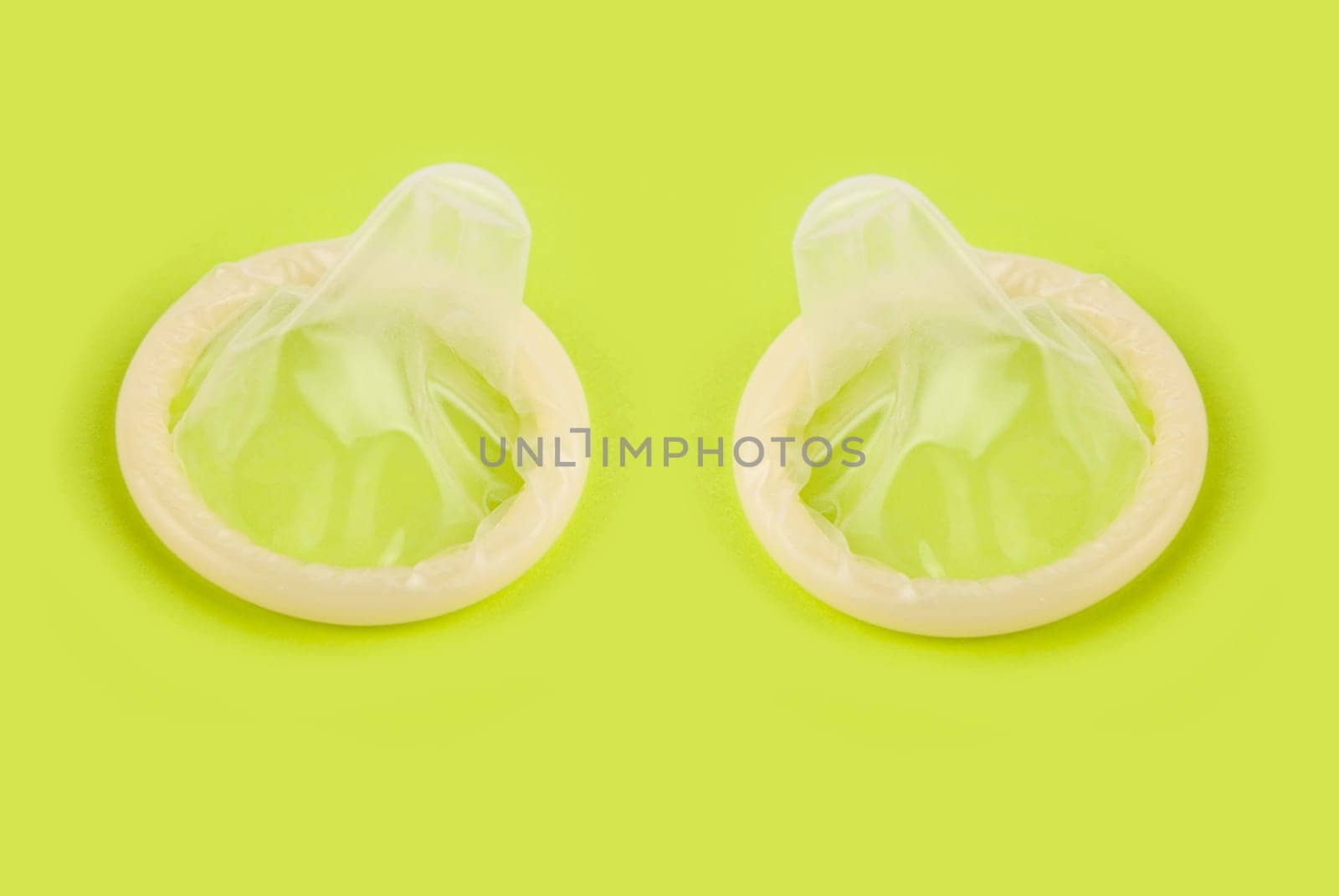 yellow condoms on green background