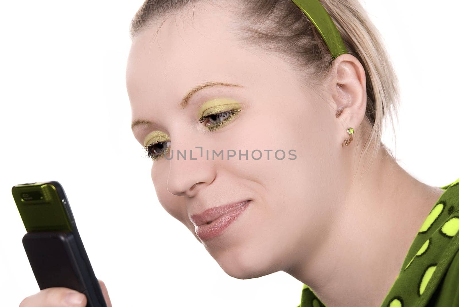 Girl in green with mobile phone on white